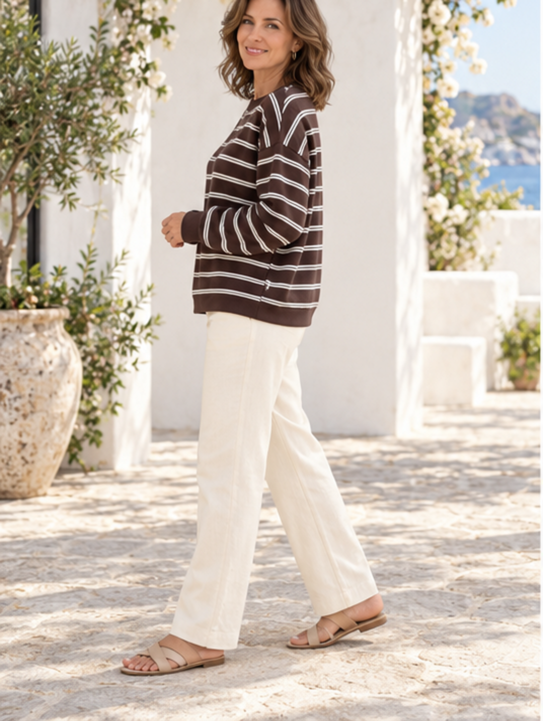 Striped long-sleeve crew-neck top, side profile view