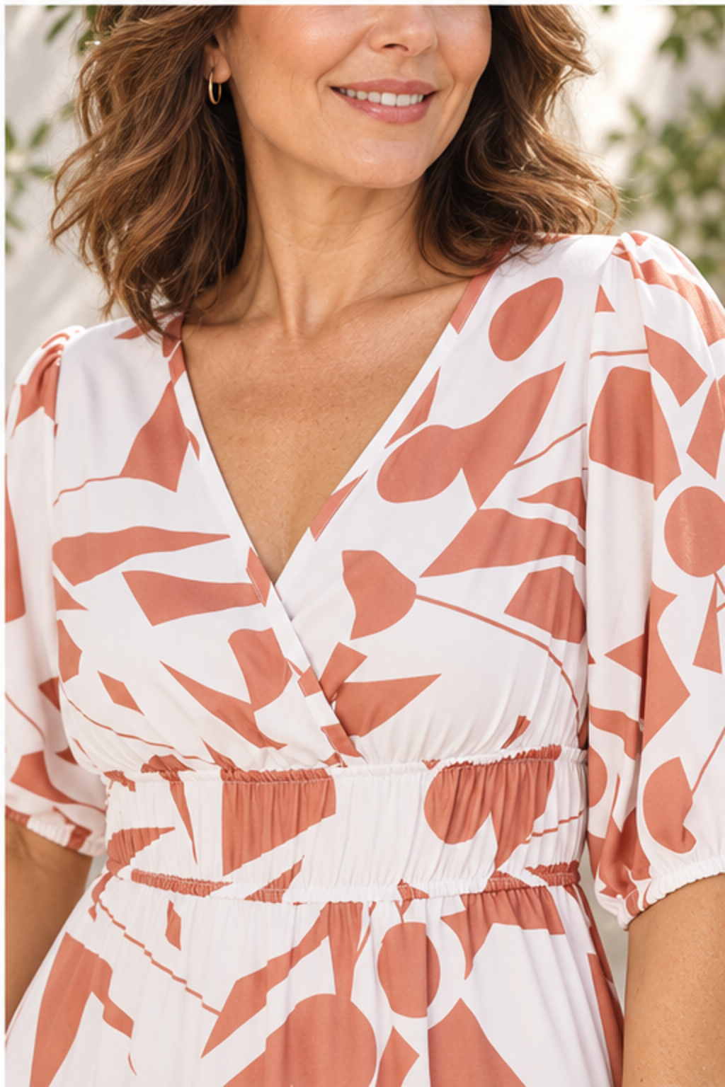 Printed surplice balloon sleeve dress in camel, close-up of print, neckline, sleeves and smocked waist