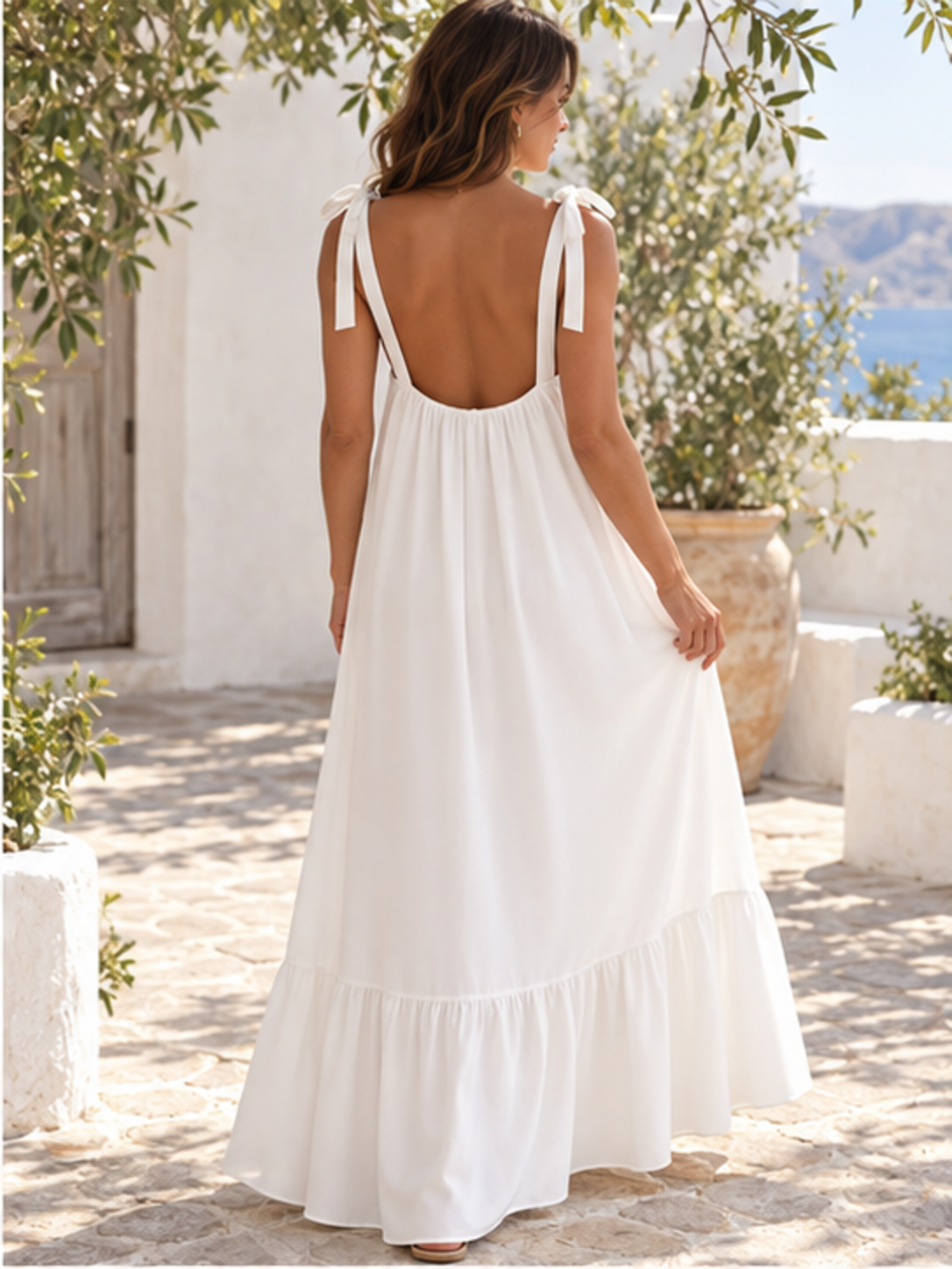 Sleeveless tie-strap flowy maxi dress in white, back full-length view showing the tied shoulder straps